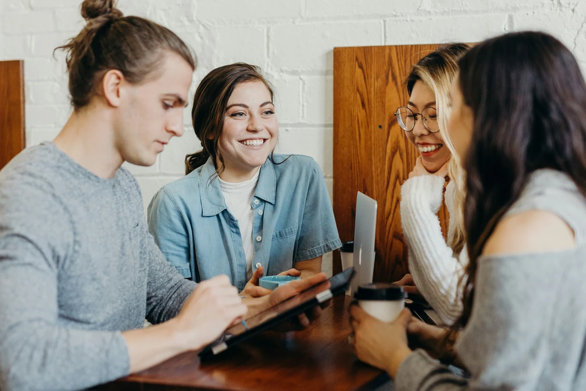 A PeerPower Ambassador with a group of peer researchers around a table